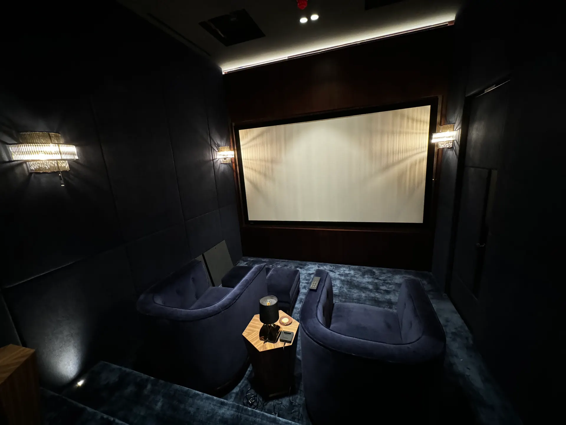 Smart home living area with integrated lighting, audio, and control systems.